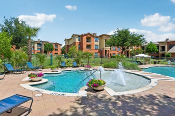 Oversized resort style swimming pool with cascading fountains